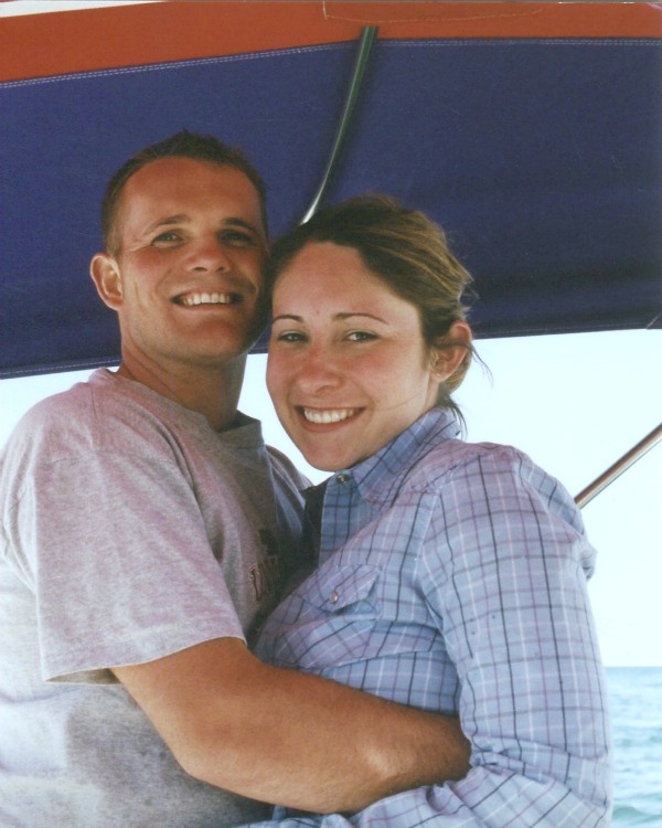 Photo of Kelly and Andie back in 2001 when they were young newlyweds. They are on a boat and they are cuddled up and clearly in love. Even after 20+ years of marriage Andie often asks how well do I know my husband? 