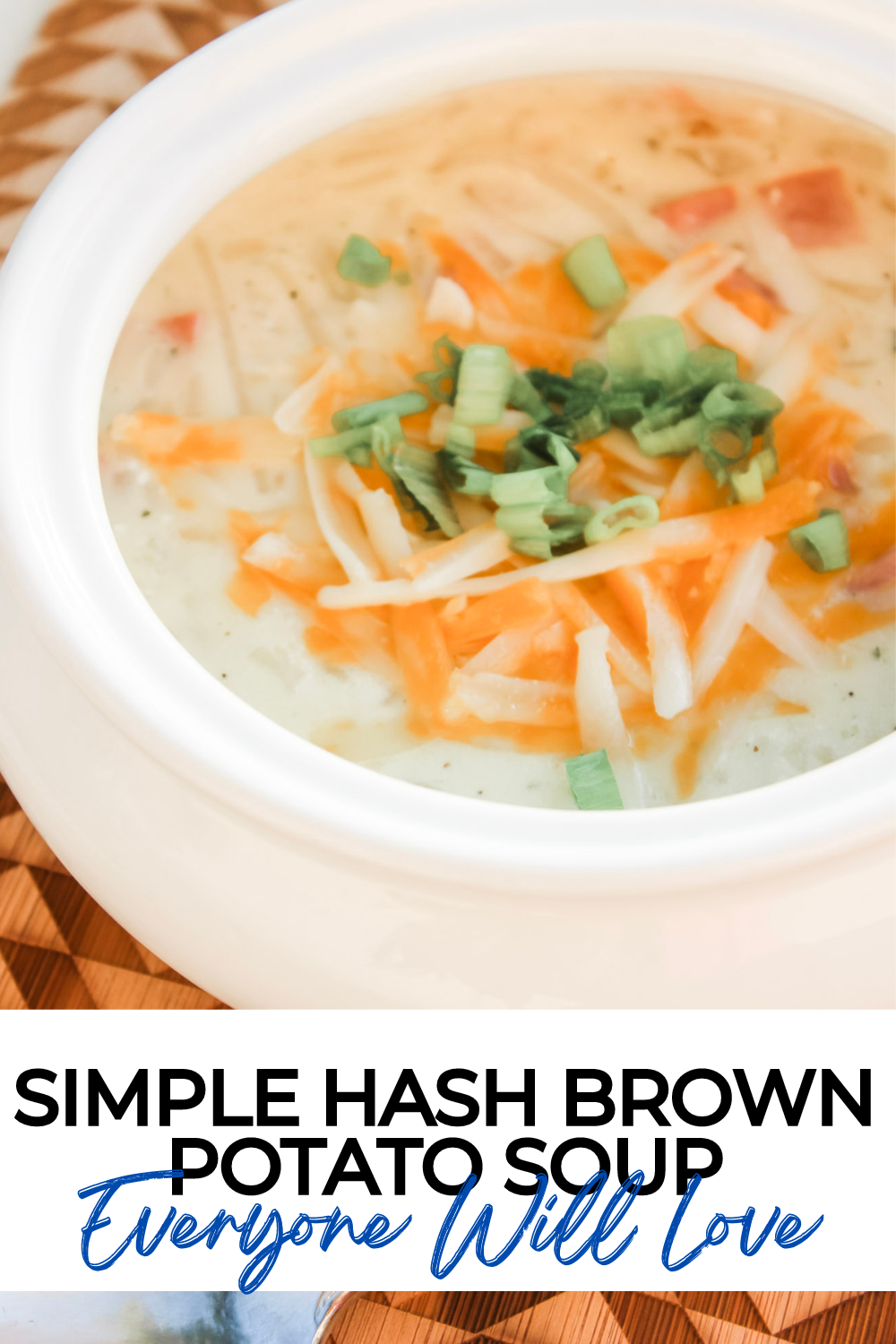 Close up of this simple hash brown potato soup recipe, soup is served in a white bowl topped with green onions, sharp cheddar cheese and a dollop of sour cream. 