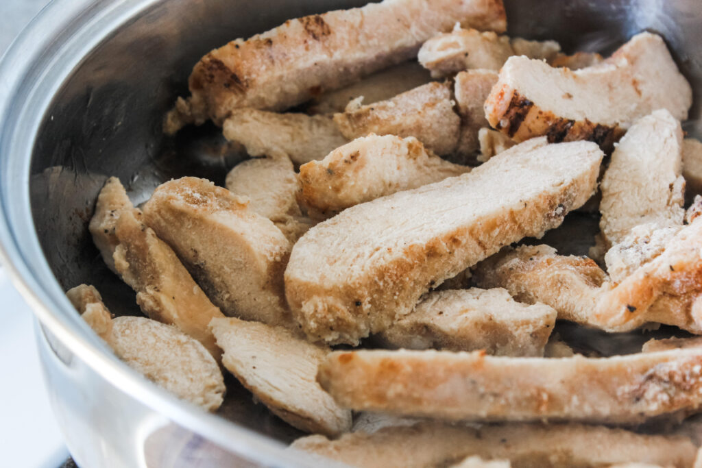 close up of Grilled Chicken Strips in pan 