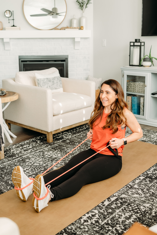 Seated rows with a resistance band are another amazing movement for sculpting your back, Andie is demonstrating how to correctly complete the movement in this back and bicep workout for women. 
