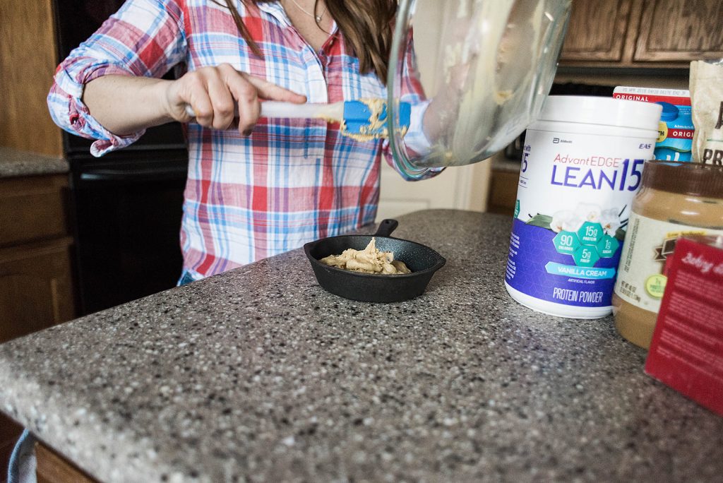 Photo of Andie scooping dough into the prepared skillet for baking