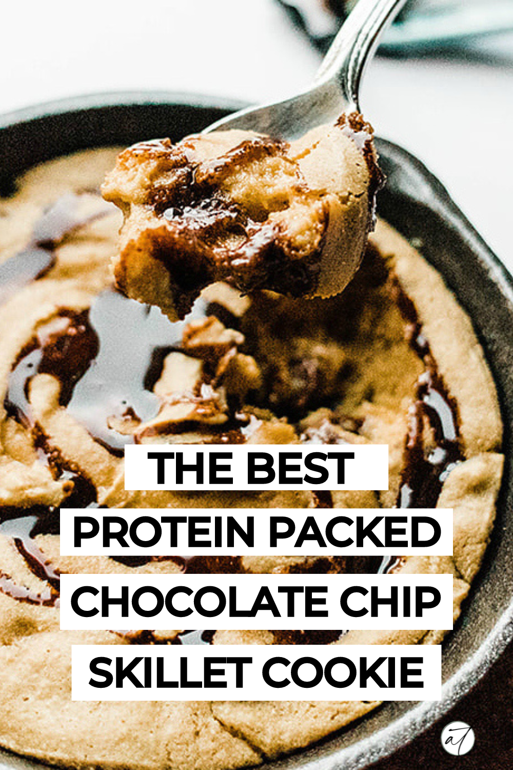 up-close photo of protein skillet cookie with a spoon dipping in for a bite.