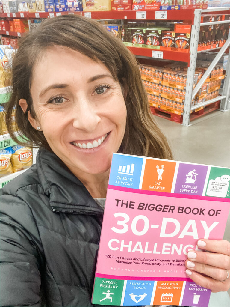 Manifesting Works! I manifested a book deal! Photo of Andie at a Sam's Club holding the book she published! 