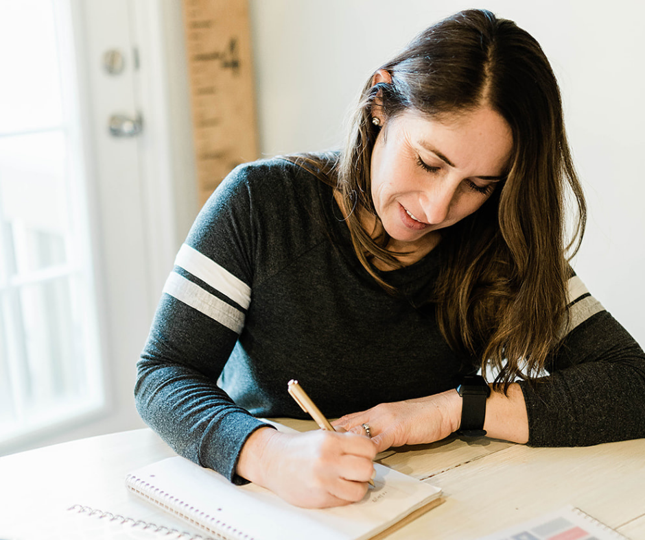 Photo of Andie journaling about gratitude in her life. One of the practices to add while watching out for words that block the law of attraction.