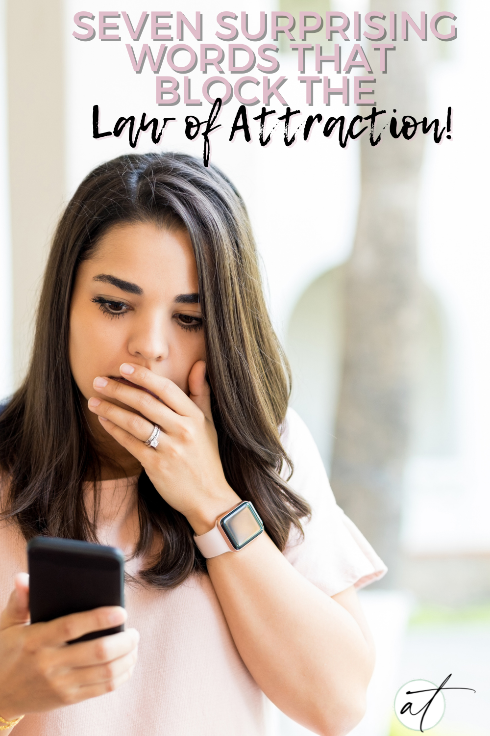 Photo of woman surprised and covering her mouth as she reads the seven words that block the law of attraction.