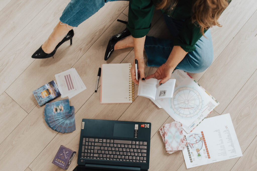Andie reviewing a human design and astrology chart, she uses these tools to help her clients discover their soul purpose.