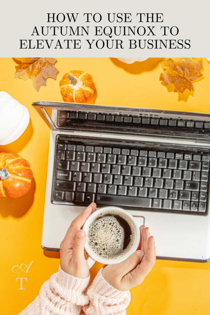 Photo of  a laptop and a gal drinking tea from a warm mug, the photo has a very strong autumn equinox / fall vibe to it. 