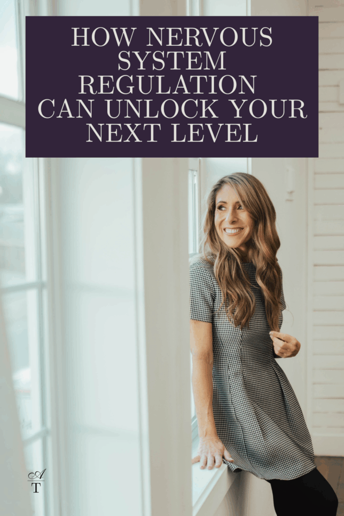 photo of Andie leaning against a wall next to open window in a white studio space , she is wearing a white and black houndstooth print dress. She looks relaxed and at ease. the words  "How Nervous System Regulation 
Can Unlock Your Next Level" are written on the image. 